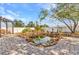 Relaxing backyard pond with rock surround and water lilies, with brick paver patio and white fencing at 6753 Thorman Rd, Port Charlotte, FL 33981
