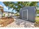 Backyard shed with a brick paver path leading to the patio in a landscaped backyard at 6753 Thorman Rd, Port Charlotte, FL 33981