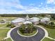 Aerial view of community clubhouse, showcasing its elegant design, surrounding landscaping, and recreational amenities at 857 Macaw Cir, Venice, FL 34285