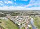 Aerial view of a residential community with lakes, golf courses, and beautiful landscaping at 857 Macaw Cir, Venice, FL 34285