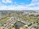 Aerial view of a residential community with lakes, golf courses, and manicured landscaping near the coast at 857 Macaw Cir, Venice, FL 34285