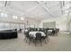 Expansive banquet hall with elegant chandeliers, tables set for an event, and large windows providing ample natural light at 857 Macaw Cir, Venice, FL 34285