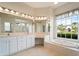 Bathroom with a large tub, dual sinks, and vanity at 857 Macaw Cir, Venice, FL 34285