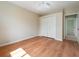 Spacious bedroom with wood floors, a ceiling fan, a closet, and base molding at 857 Macaw Cir, Venice, FL 34285