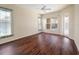 Bright bedroom features beautiful wood floors, a ceiling fan, and natural light at 857 Macaw Cir, Venice, FL 34285