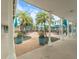 Charming courtyard with outdoor seating, palm trees, and shaded areas for relaxation and socializing at 857 Macaw Cir, Venice, FL 34285