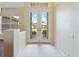 Entryway with tile floors, white walls, natural light, and double doors leading to an outdoor view at 857 Macaw Cir, Venice, FL 34285