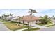 Beautiful single-story home with a well-manicured lawn, two car garage, and lovely landscaping with Palm Trees at 857 Macaw Cir, Venice, FL 34285