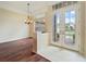 Foyer with hardwood floors and natural lighting from the windows and glass double doors offering an outdoor view at 857 Macaw Cir, Venice, FL 34285
