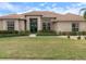 Inviting home with a well-maintained lawn, lush landscaping and a beautiful red tile roof at 857 Macaw Cir, Venice, FL 34285