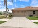 Exterior shot of a home showcasing a two-car garage and spacious driveway at 857 Macaw Cir, Venice, FL 34285