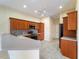 Bright kitchen featuring breakfast bar, tile floors, stainless steel appliances and warm wood cabinets at 857 Macaw Cir, Venice, FL 34285