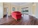 Spacious living room with hardwood floors and view to the screened in pool area at 857 Macaw Cir, Venice, FL 34285