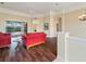 Spacious living room with hardwood floors and view to the screened in pool area at 857 Macaw Cir, Venice, FL 34285