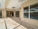Covered patio with brick pavers and views of the pool and backyard at 857 Macaw Cir, Venice, FL 34285