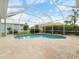 Screened-in pool with patio, landscaping, and partial home view at 857 Macaw Cir, Venice, FL 34285