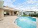 Screened-in pool with patio, landscaping, and partial home view at 857 Macaw Cir, Venice, FL 34285