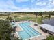 Aerial view of a community pool surrounded by a golf course and lush landscaping at 857 Macaw Cir, Venice, FL 34285