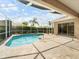 Screened-in pool with patio, landscaping, and partial home view at 857 Macaw Cir, Venice, FL 34285