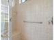 Walk-in shower features a grab bar and built-in bench at 857 Macaw Cir, Venice, FL 34285