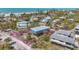 Aerial shot of a two-story home with a deck and a manicured lawn at 9390 Little Gasparilla Island, Placida, FL 33946