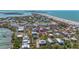Aerial view showcasing a blue house with a metal roof, surrounded by lush landscaping at 9390 Little Gasparilla Island, Placida, FL 33946