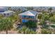 Aerial view of a charming home with a metal roof and a surrounding landscape of palm trees at 9390 Little Gasparilla Island, Placida, FL 33946