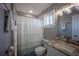 Updated bathroom featuring granite countertop vanity, shower-tub combo and modern lighting fixtures at 9390 Little Gasparilla Island, Placida, FL 33946