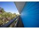 The home's light blue exterior, deck, and tropical vegetation at 9390 Little Gasparilla Island, Placida, FL 33946