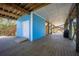 A ground floor wooden structure with a ramp, a white door, and a large deck at 9390 Little Gasparilla Island, Placida, FL 33946