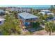 Stunning elevated beach house with wood decks, lush landscaping, and a metal roof with ocean view at 9390 Little Gasparilla Island, Placida, FL 33946