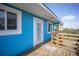 Charming blue home featuring a wooden deck and stylish white trim at 9390 Little Gasparilla Island, Placida, FL 33946