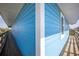 The home's light blue exterior contrasted with white trim and wooden deck at 9390 Little Gasparilla Island, Placida, FL 33946