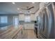 Bright kitchen with stainless steel appliances, expansive island with bar seating, and stylish backsplash at 9390 Little Gasparilla Island, Placida, FL 33946