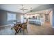 An open-concept kitchen featuring a large island with seating, stainless steel appliances, and white cabinetry at 9390 Little Gasparilla Island, Placida, FL 33946