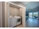 Convenient laundry room with washer and dryer, located near the open living area and backyard deck at 9390 Little Gasparilla Island, Placida, FL 33946