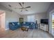 Cozy living room featuring comfortable blue sofas, stylish decor, and access to the outdoors at 9390 Little Gasparilla Island, Placida, FL 33946