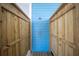 An outdoor shower stall with wood plank walls and chrome fixtures at 9390 Little Gasparilla Island, Placida, FL 33946