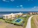 Stunning aerial view of a condo complex with tennis court and waterfront views at 101 N Marion Ct # 215, Punta Gorda, FL 33950