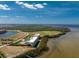 An aerial view of end unit waterfront condos with a pool and tennis court and easy access to the water at 101 N Marion Ct # 215, Punta Gorda, FL 33950