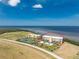 Aerial view of a resort featuring pool and tennis court in desirable waterfront community, showcasing lifestyle amenities at 101 N Marion Ct # 215, Punta Gorda, FL 33950