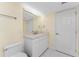 This bathroom has a single sink vanity with drawers and mirror, adjacent to the toilet and door at 101 N Marion Ct # 215, Punta Gorda, FL 33950