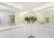 Bathroom featuring dual sinks, tile flooring, a large mirror, and a shower at 101 N Marion Ct # 215, Punta Gorda, FL 33950