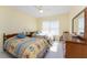 This bedroom features two twin beds, a window with blinds, and a wood dresser with mirror at 101 N Marion Ct # 215, Punta Gorda, FL 33950