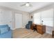 Bedroom featuring a desk, white closets, comfortable seating and wood grain vinyl floors at 101 N Marion Ct # 215, Punta Gorda, FL 33950