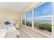 Bedroom featuring bright windows with ocean views and neutral decor at 101 N Marion Ct # 215, Punta Gorda, FL 33950
