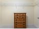 Walk-in closet featuring wire shelving and a wood dresser for organization and storage at 101 N Marion Ct # 215, Punta Gorda, FL 33950