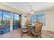 Dining area featuring wood floors, glass table, and sliding glass doors to balcony at 101 N Marion Ct # 215, Punta Gorda, FL 33950