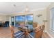 Dining area with a glass table, seating for four, and access to a private balcony with water view at 101 N Marion Ct # 215, Punta Gorda, FL 33950