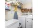 Convenient laundry room with a sink, washer and dryer, and ample shelving for storage at 101 N Marion Ct # 215, Punta Gorda, FL 33950